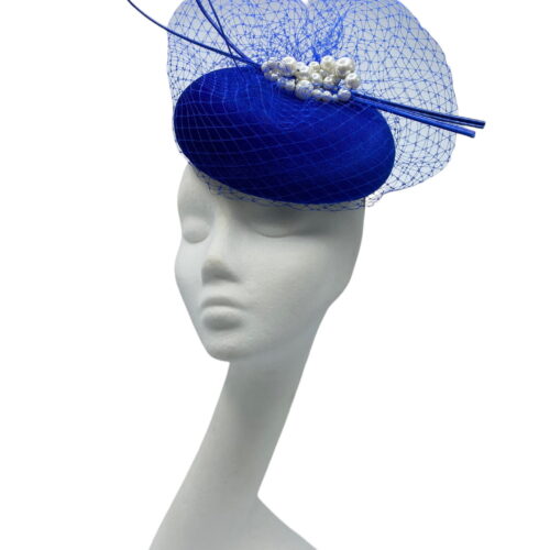 Blue velvet pillbox with stunning blue veiling, blue quills and knotted pearl detail.
